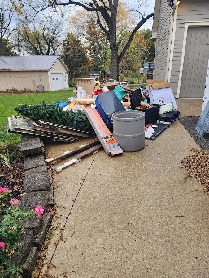 Dumpster being loaded with debris for Residential Dumpster Rental in Lucedale